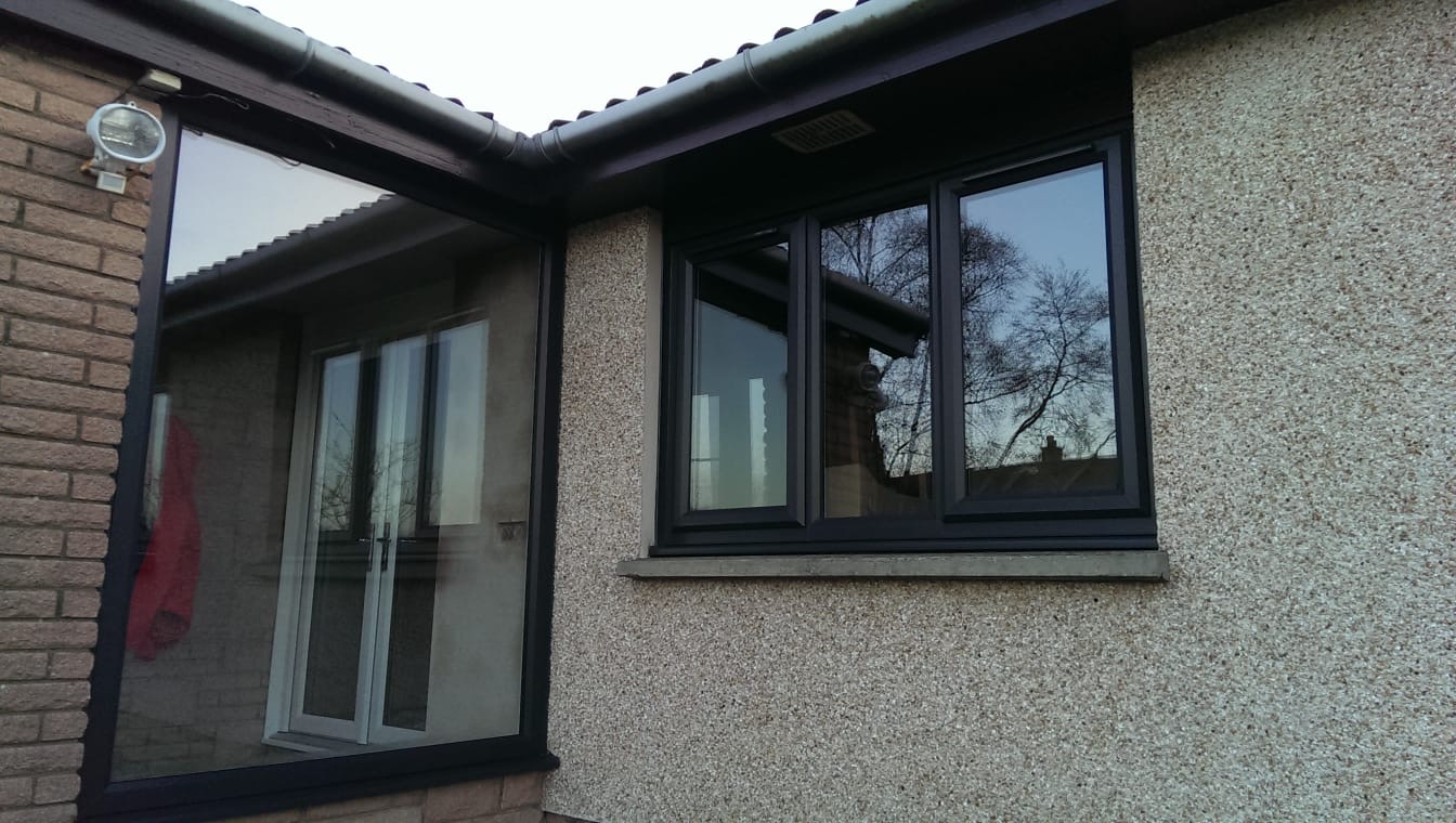 House extension with anthracite grey sliding patio door and matching windows