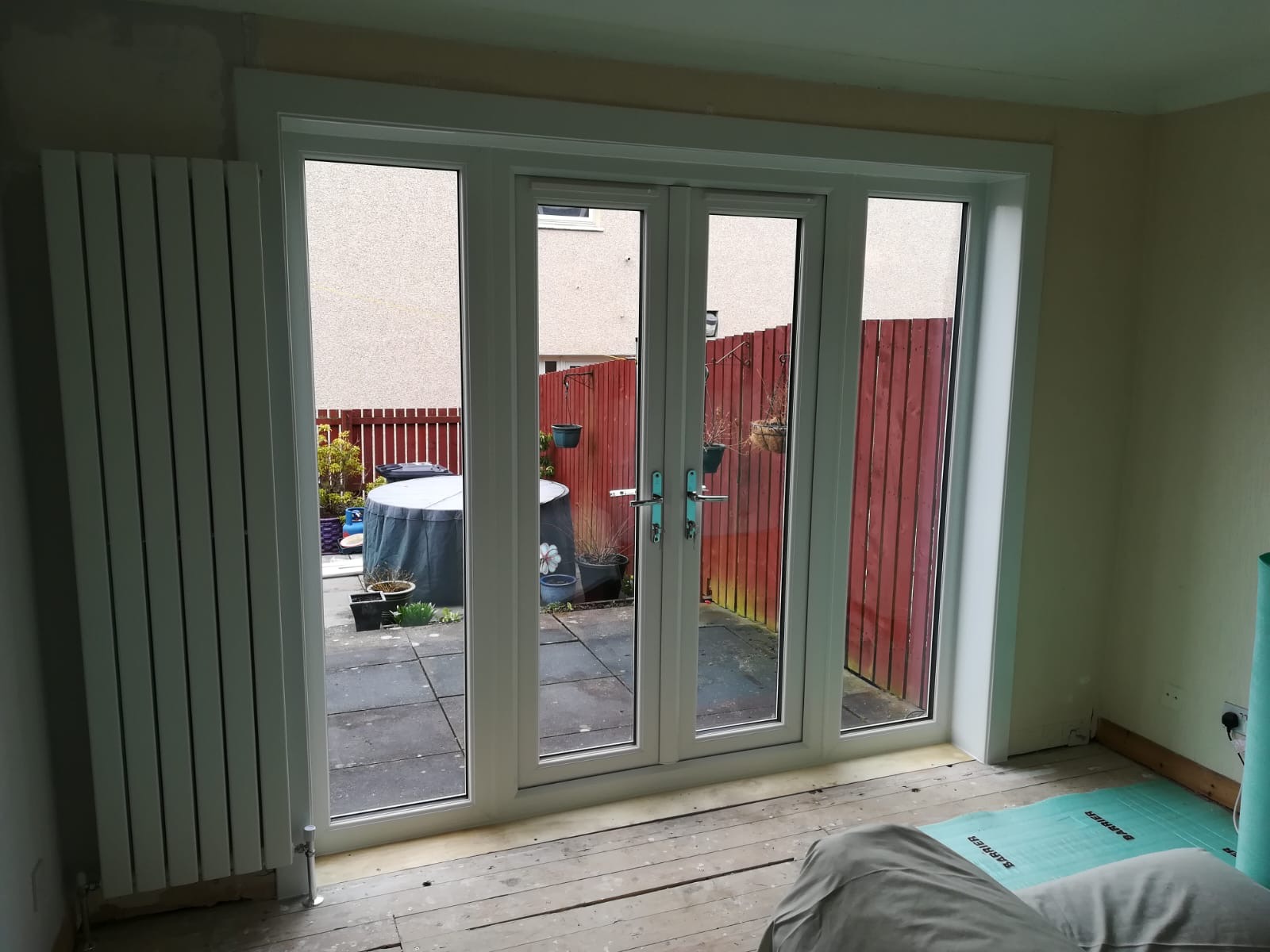 White uPVC French doors opening to back garden patio
